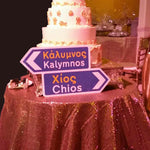 A Greek road sign next to a greek wedding cake